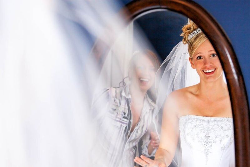 Bride getting ready in front of a mirror
