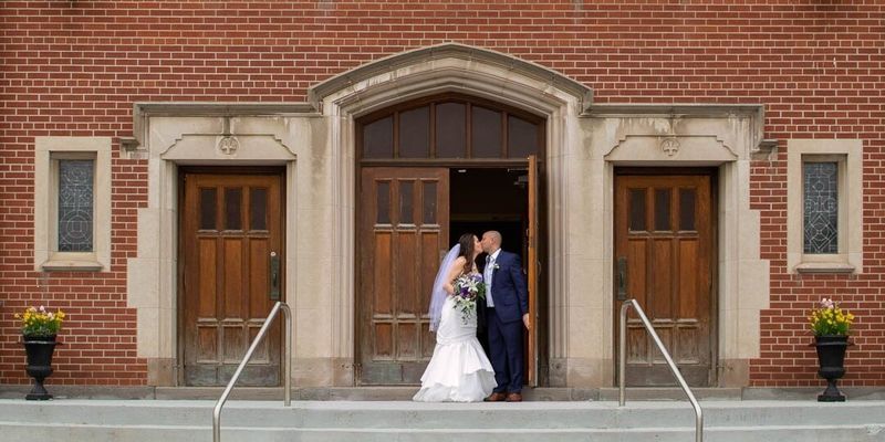 Couple kissing in a church after their ceremony