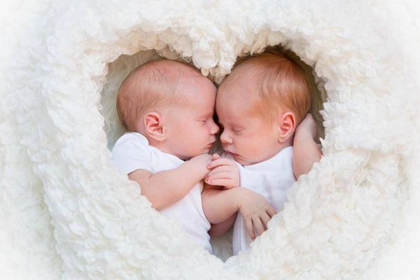 Newborn twins on a heart blanket